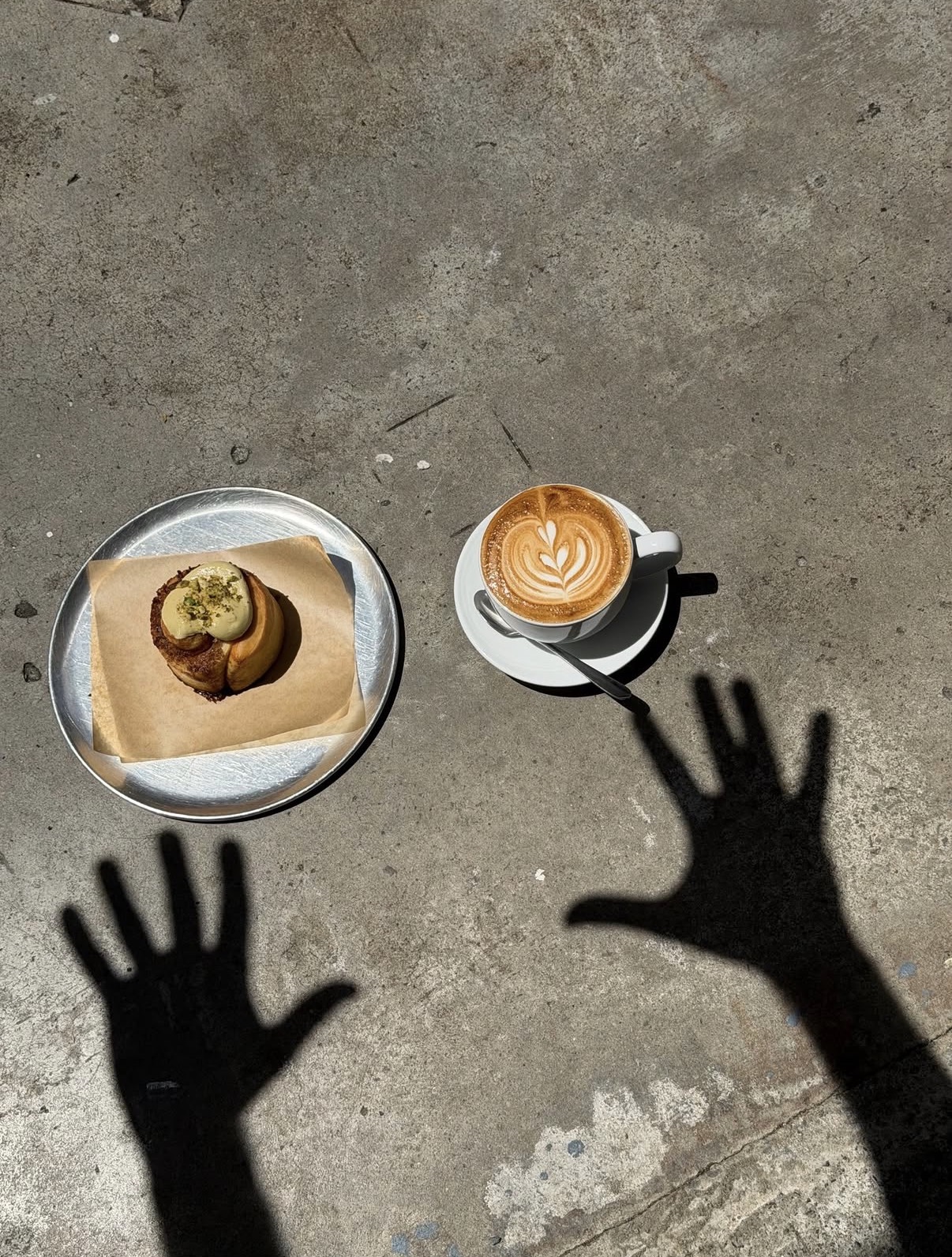 Cinnamon roll and latte flat lay